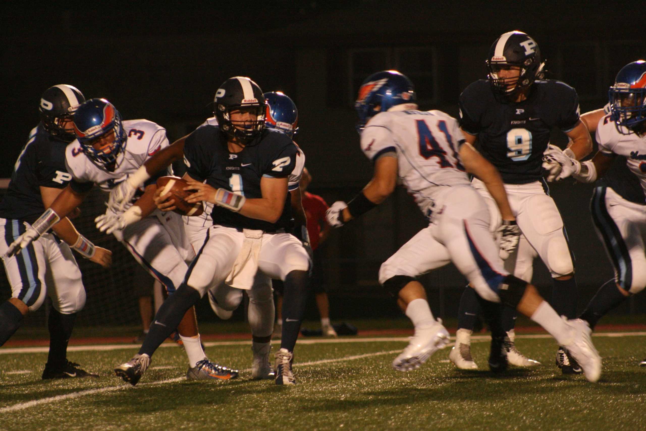 Senior quarterback Matt Drew pauses during the Hoffman Estates game Friday, September 4. The Knights are aiming to improve their overall record to 2-1 after the game against Fremd. (Photo by Cassidy Selep)