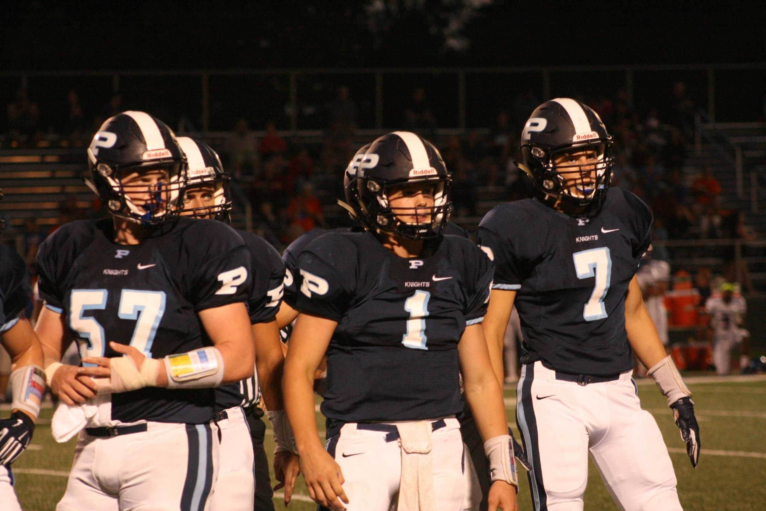 Seniors Luke Wrede and Matt Drew line up to snap the ball against Jacobs High School on Aug. 28. Wrede and Drew have both been on varsity since their sophomore seasons, playing center and quarterback. "I want my senior year team to put Prospect where we belong, on top of the east and in the playoffs," Wrede said. (Photo by Cassidy Selep)