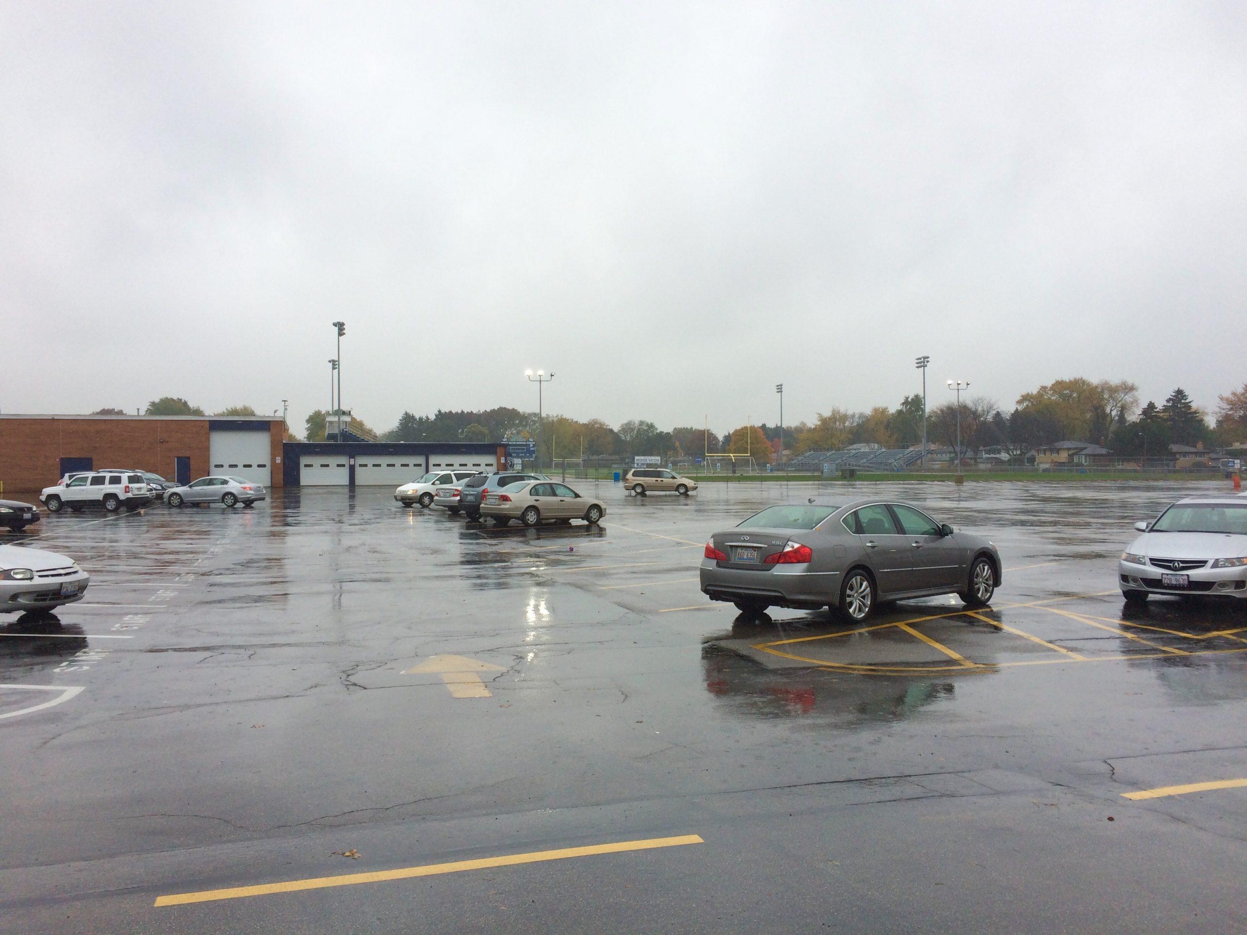 The parking lot sits partially occupied on a Saturday morning. Parking permit sales have abruptly stopped after the school has run out of remaining spaces. (photo by Riley Langefeld)