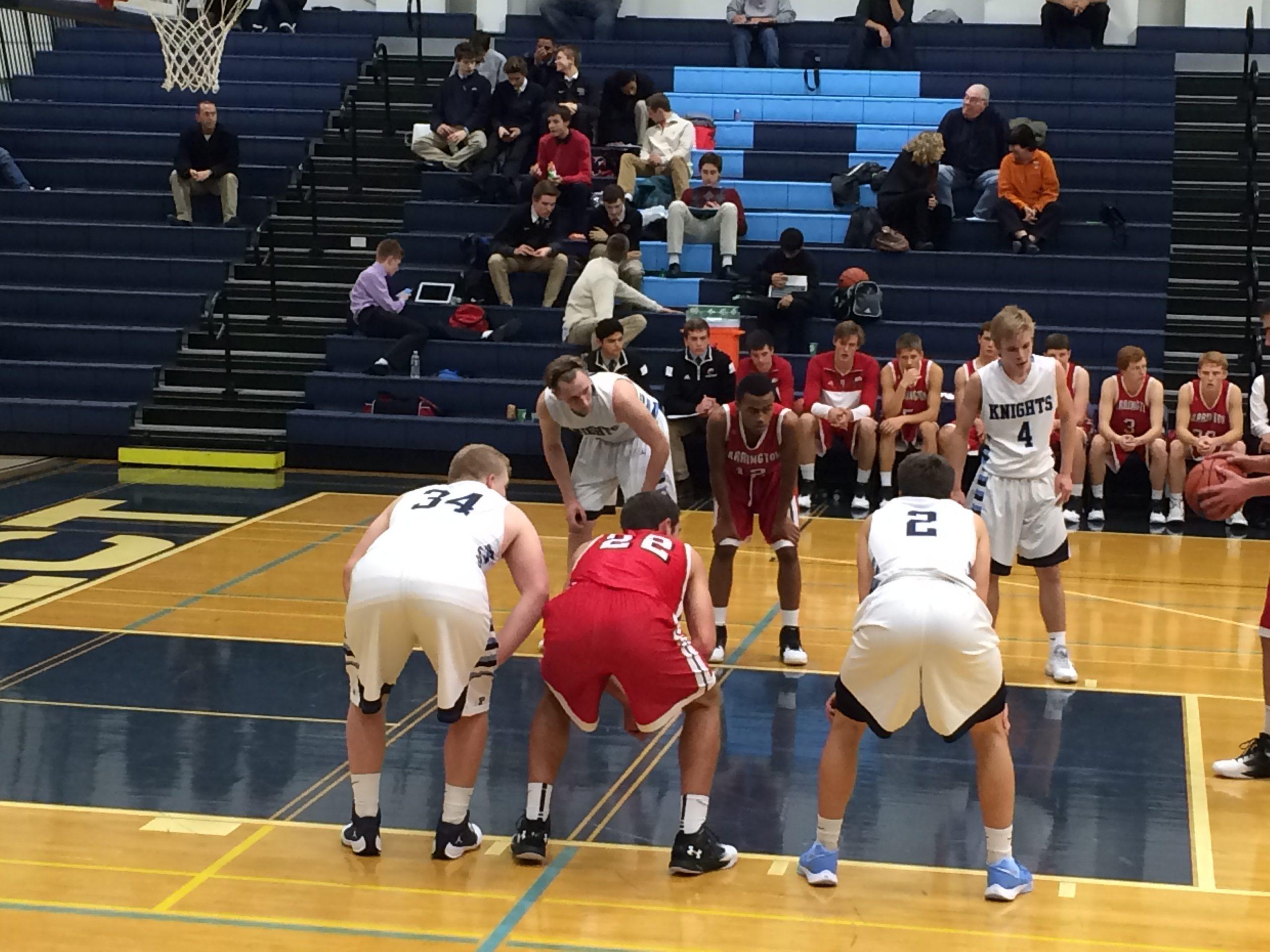 GET BUCKETS: Seniors Luke Wrede and Dan Marshall along with junior Matt Szuba and Sophomore David Swedura stand anxiously waiting a free throw attempt during Tuesday, Dec. 8’s varsity basketball game against the visiting Broncos of Barrington High School. The Knights took home their second home victory and improved their record to 3-3. (photo courtesy of Tricia Marshall)
