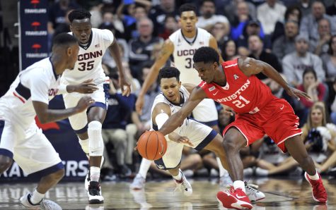 Connecticuts Jalen Adams (2) dives on the floor for a steal against Houstons Damyean Dotson (21) at Gampel Pavilion in Storrs, Conn., on Sunday, Feb. 28, 2016. Houston won, 75-68. (Photo by Tribune News Service)
