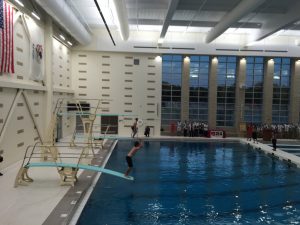 Sophomores Aidan and Aaron Busiel take commemorative first dives into the pool. The brothers capped off the dedication ceremony.