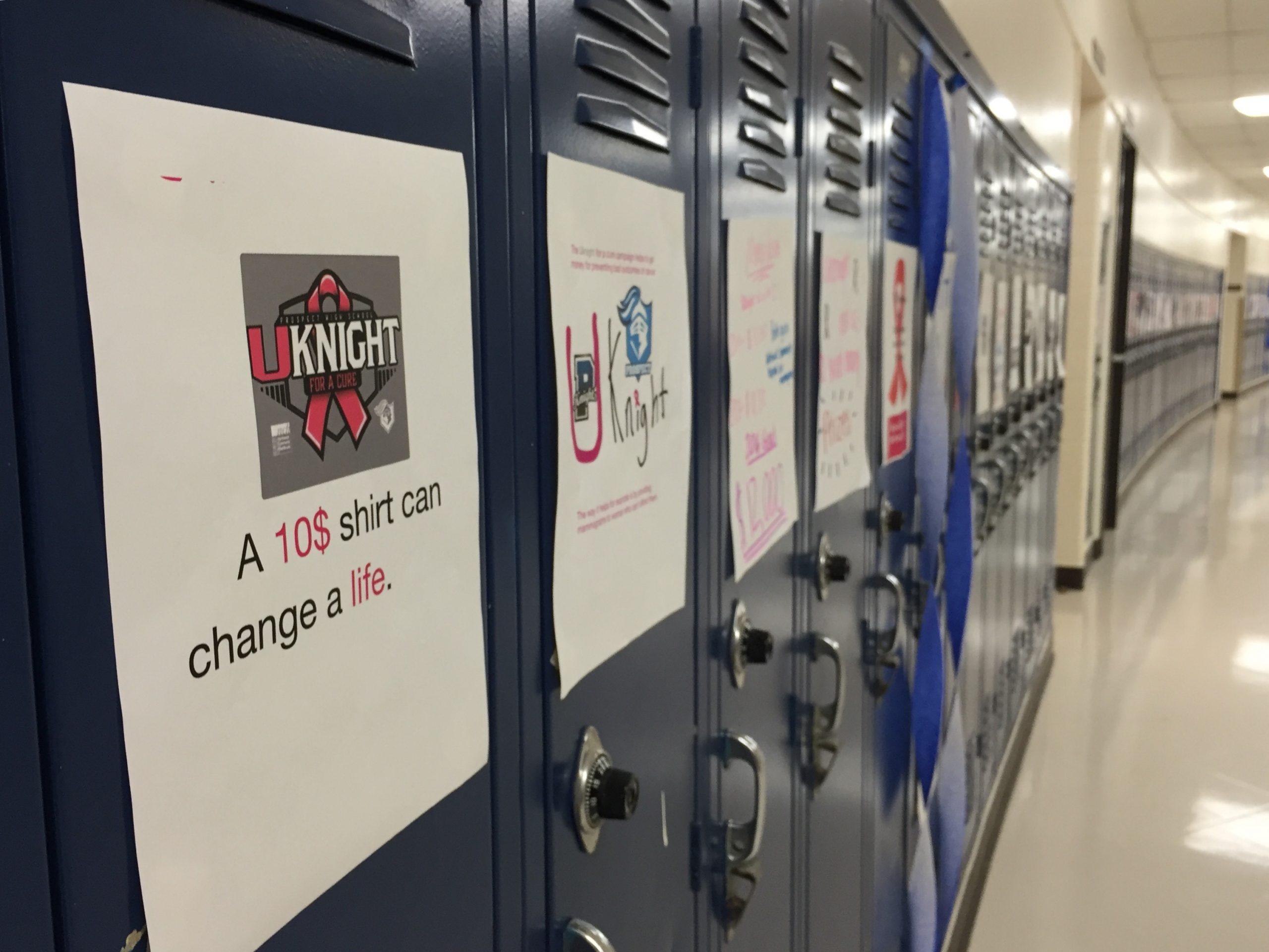 Posters created by the freshman class promoting Friday’s U-Knight for a Cure football game and T-shirt line the halls.
