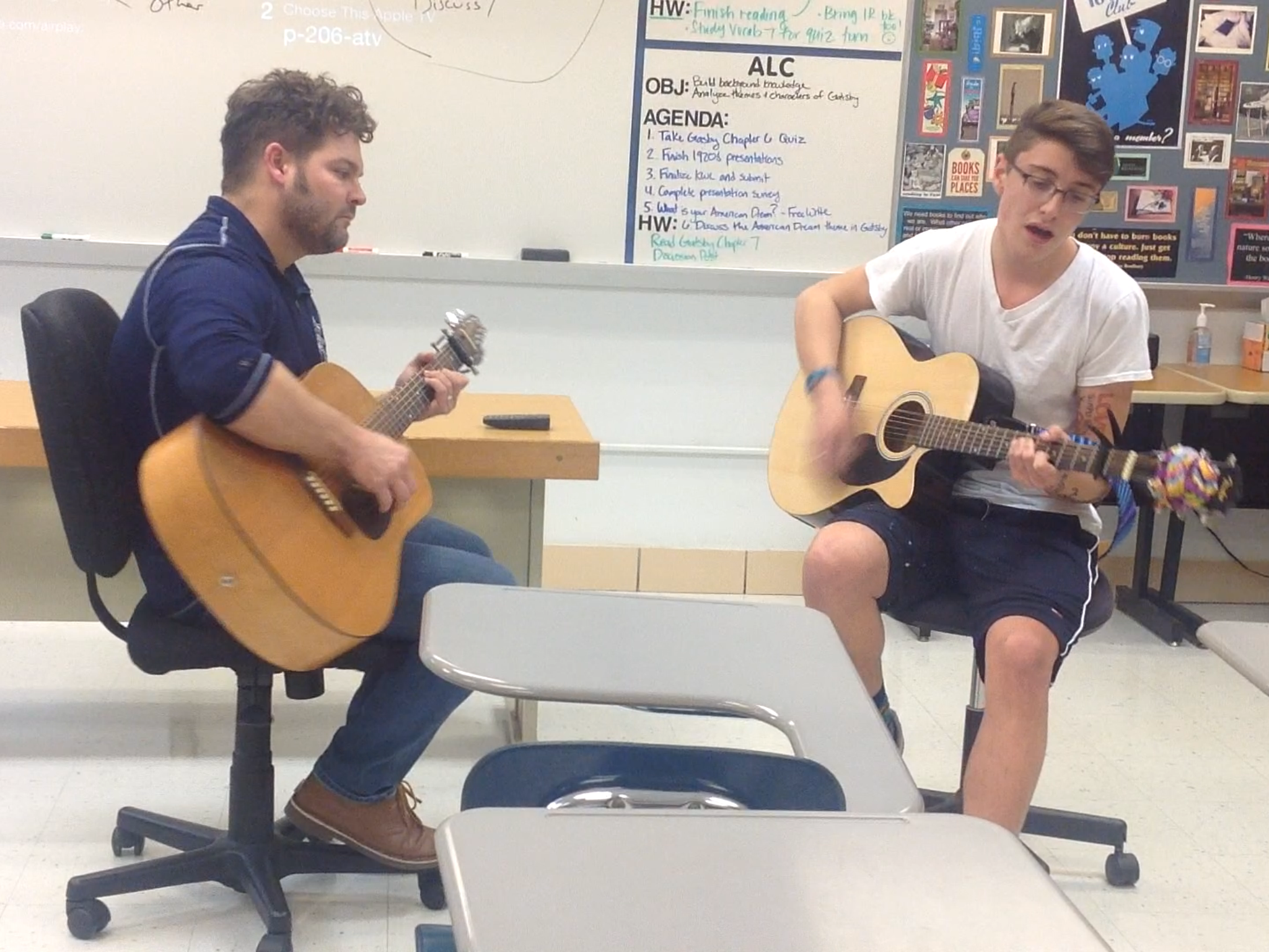 English teacher Michael Andrews helps junior Mike Gambino practice for Roundtable and Guitar Club's open mic night on Dec. 14.