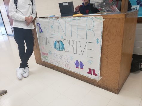 Green team coat drive collecting donations