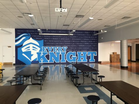 A new mural featuring the words EVERY KNIGHT and Welcome in over 50 different languages and dialects now towers over the newly painted cafe.