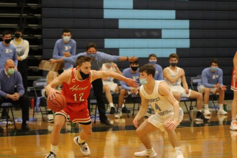 Prospect’s Owen Schneider guards Hersey’s Andrew Wagner.  (Photo by Alexis Esparza) 