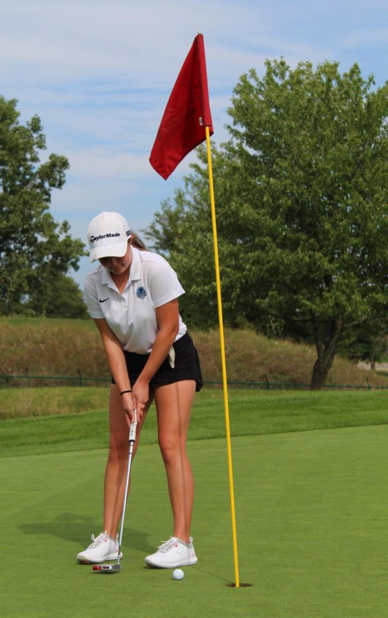 Kate Riesing secures a close putt on the green. 