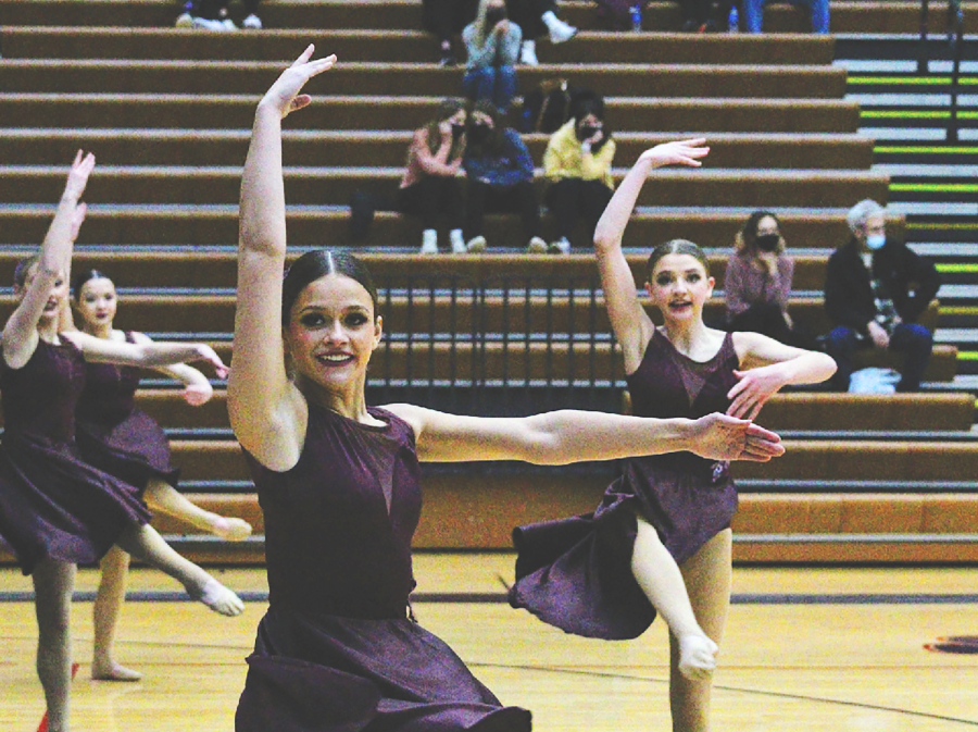 SYNCHRONIZED: Senior Ava Weber (middle) and Freshman Lucy Neuman (right) dance on the floor. The dance team was ecstatic during sectionals after learning they qualified for state 