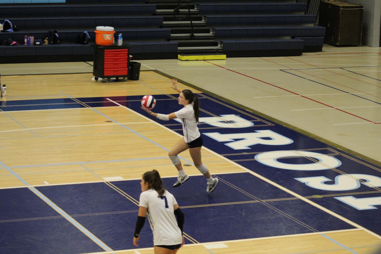 Sophomore Lucy Ross serves the ball in a game against Buffalo Grove on September 22nd. 