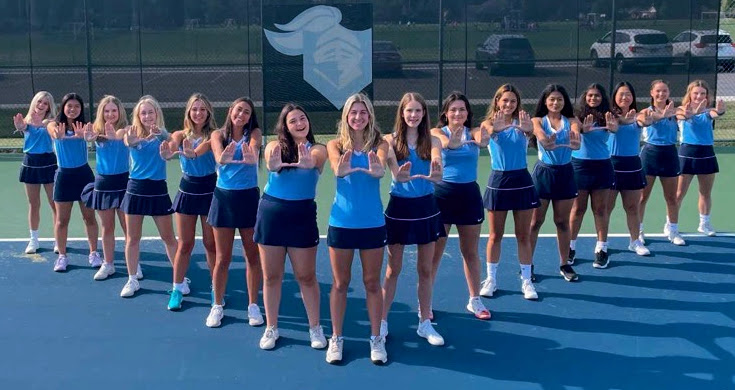Representing: the girls’ varsity tennis team lines up to show their commitment to the game. The girls are excited to get back onto the court and perform better than last year. (Photo courtesy of Mike McColaugh).