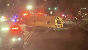 The bus that they hockey team was in lies flat on its side in the middle of the road. (Photo courtesy Henry Pisor)