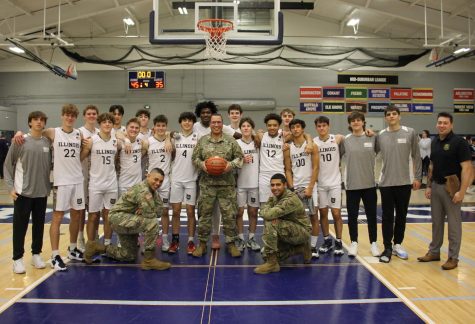 The Prospect boys basketball team poses with the National Guard members after winning the game 45-35. 