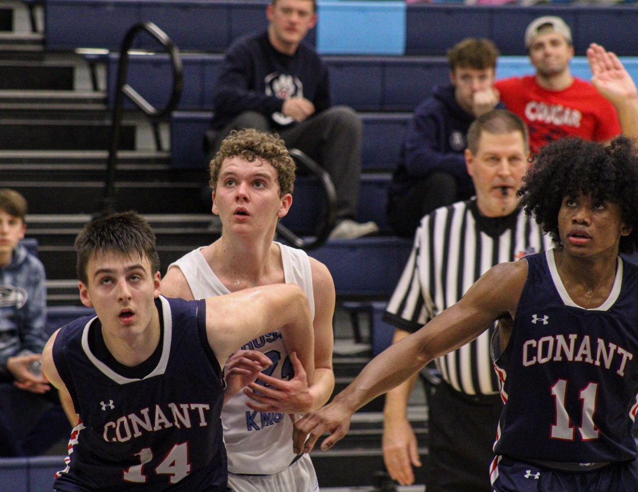 Senior Charlie Gilmer goes for rebound after Conant free throw. (All photos by Bella Brouilette)