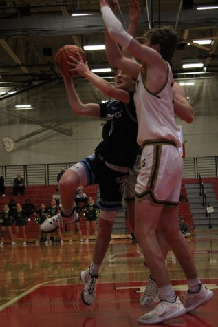 Sophomore Ben Schneider goes up for the layup against Stevenson. (Photo by Bella Brouilette)