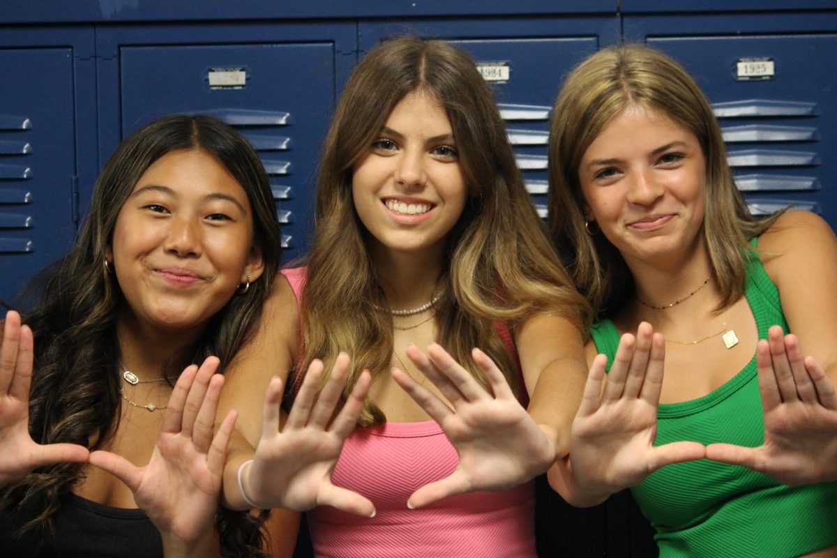 Carmela Punzalan, Julia Czeryba, and Jocelyn Kirshner showing school spirit by doing the “U”. 
