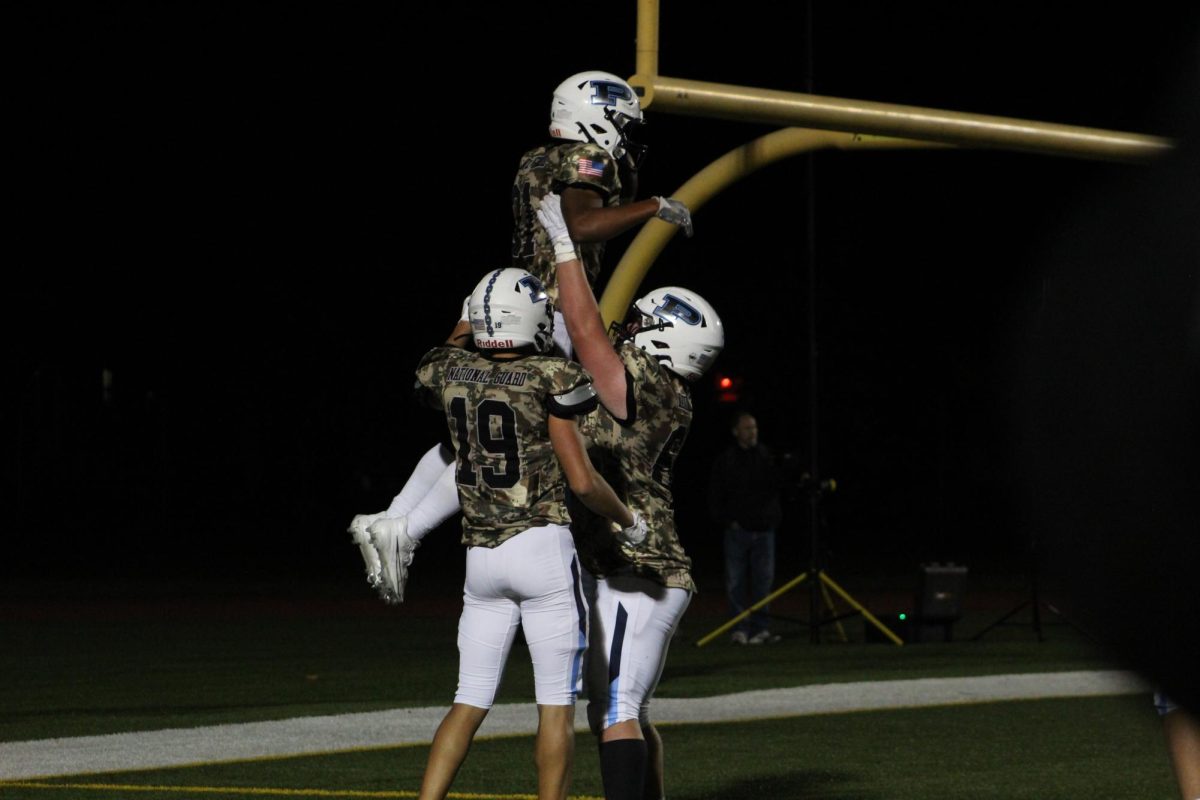 Celebrating a touchdown, Junior Noah Easter gets lifted up by his teammates.