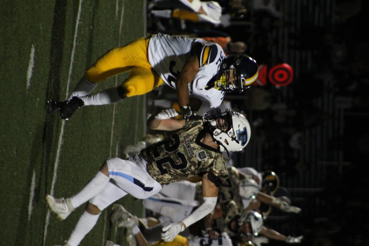 Senior Nate Tader pushes past a Glenbrook South defender.