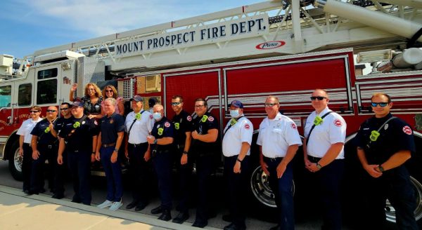 First responders standing in front of a fire truck gathering together for the honorary BBQ. (Photo courtesy of Mount Prospect Senior Living Facebook)