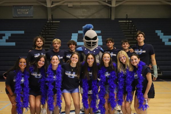 The Blue Leaders standing with the Knight mascot from the pep assembly.