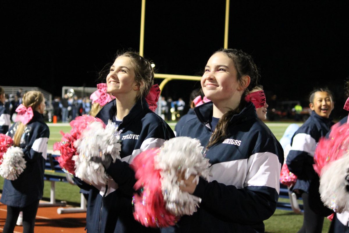 Sophomores Tessa Trylovich and Josie Grace Briggs cheering to the crowd. 
