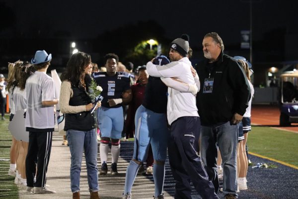 Head varsity football coach Dan DeBouef hugs senior Crash Davis at “Senior Knight”. (Photo by Priyanka Shah)