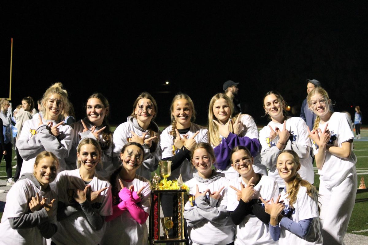 The members of Whizbang, the 2023 UFC all-girls’ division champions, pose with the trophy at Gattas Stadium.
