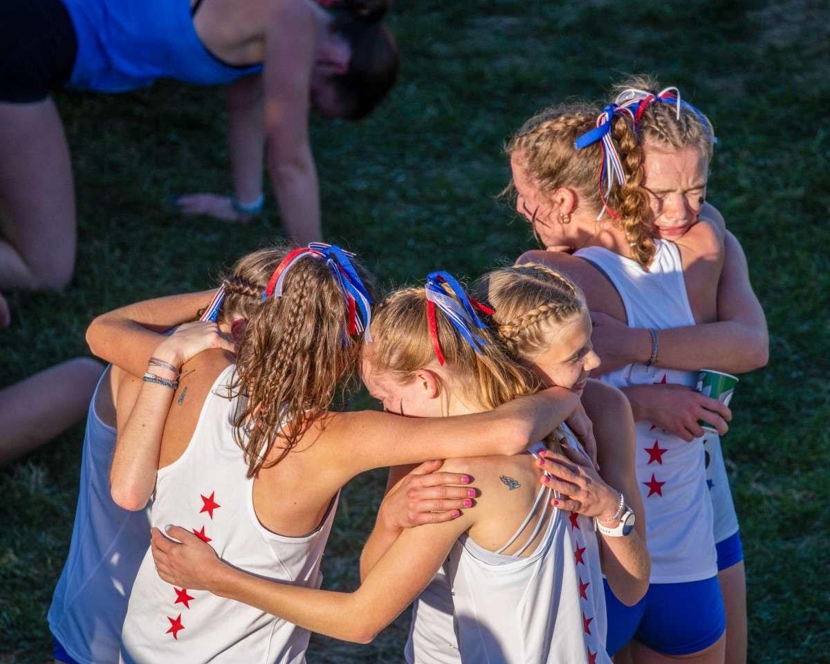 Veronica Znajda and the rest of the girls XC team sharing a team moment after the race at regionals. (Photo courtesy of Veronica Znajda).