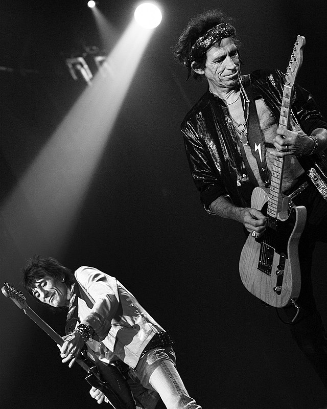 Fellow Rolling Stones guitarists Keith Richards and Ronnie Wood rock out on stage together (photo courtesy of commons.wikimedia.org).