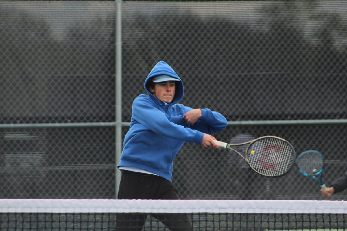 Junior Oliver Witek warms up for his match against Maine South. 