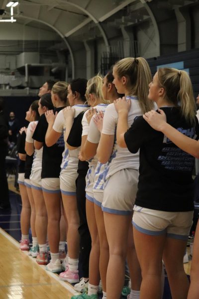Prospect girl’s basketball stands at attention during the anthem. While not required, most high school teams are on the court when the anthem begins.