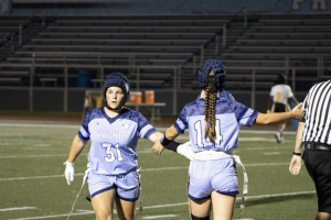 Junior quarterback Libby McDonough and sophomore Amalia Andrews high-five during the first ever Prospect Girls’ Flag Football game. McDonough and Andrews connected for the first ever touchdown in Prospect Girls’ Flag Football history.