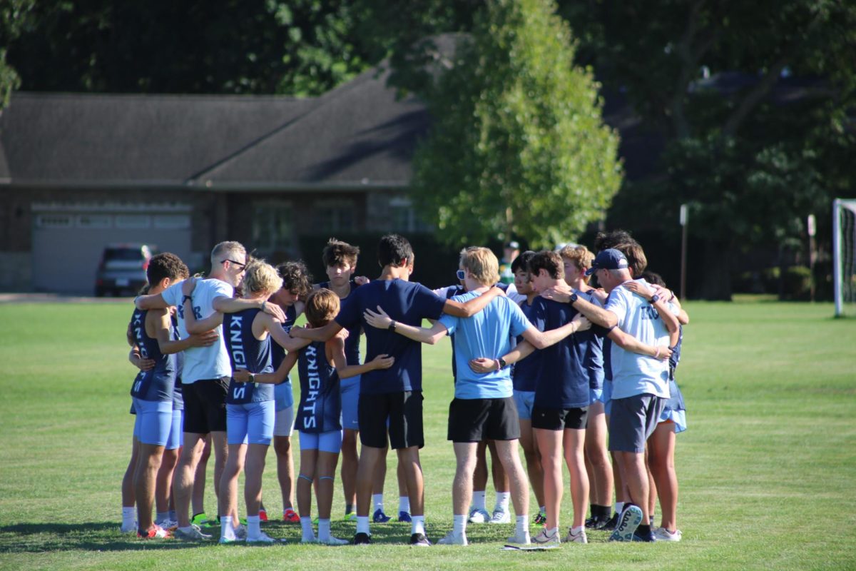 Boys JV Cross Country huddles up before running the 2.5 mile race at Prospect High School at the first meet of the season.