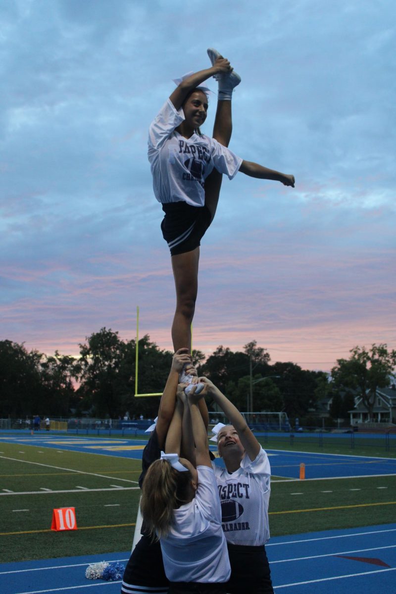 Sophomore Mia Michalek pulling a bow and arrow in a stunt.
