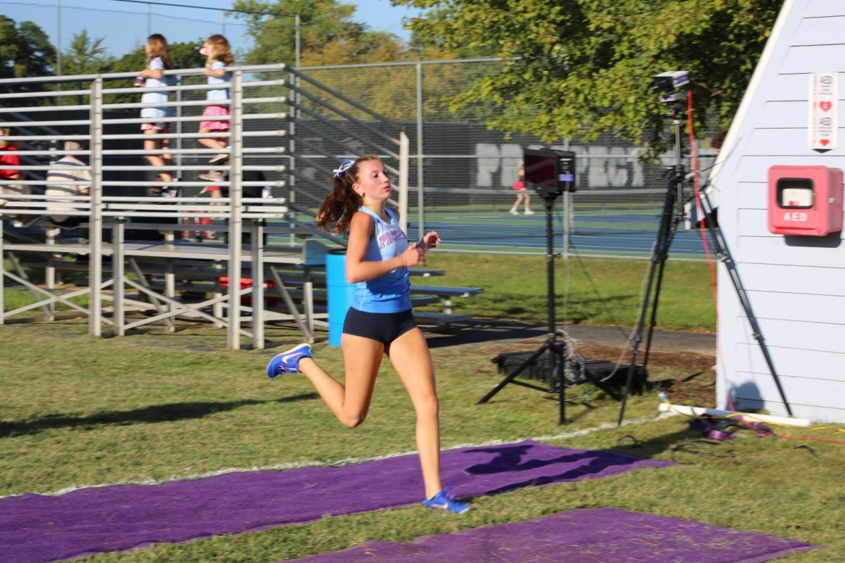 Sophomore Mali Scorza finishes first in her race.