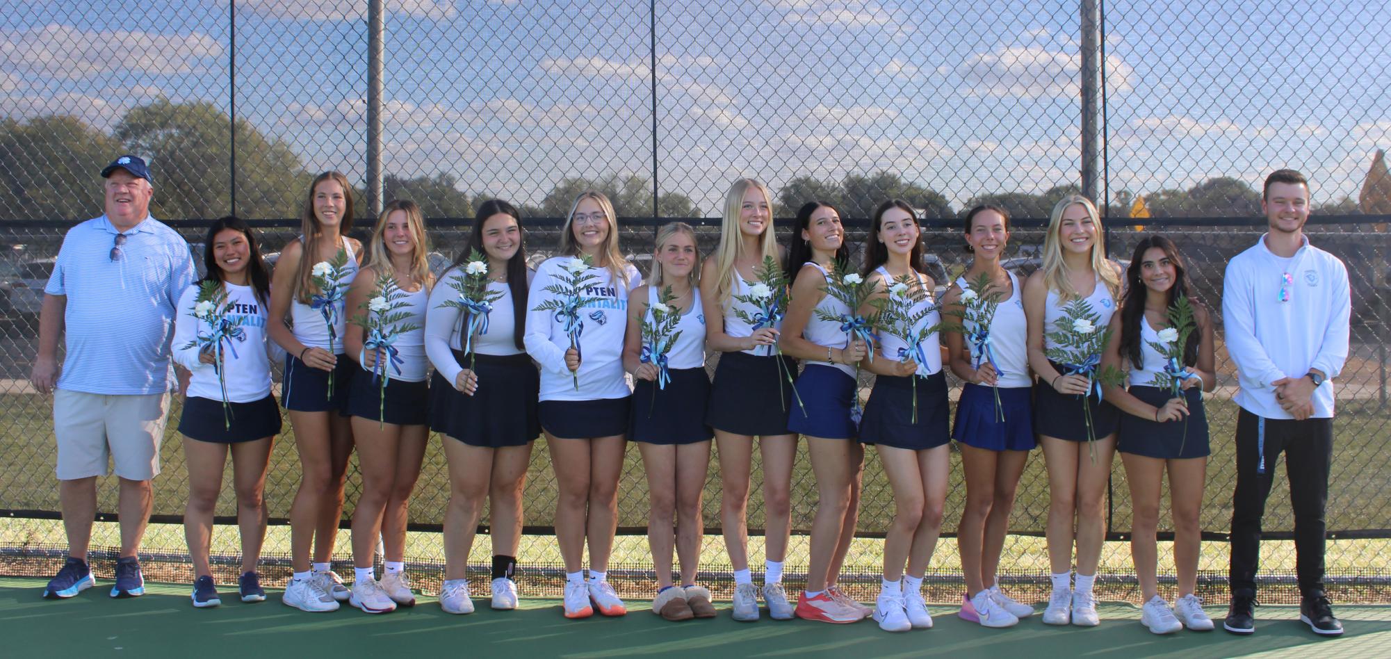 All of the girl’s tennis seniors and former teacher Mike McColaugh (left) and current head coach Patrick Weber (right).
