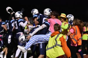 Blue leaders greet the football team in the end zone after the win. (Photo by Claire Wynkoop)