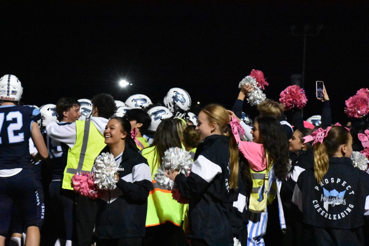 Prospect celebrates their first win against Hersey in 3 years with the student section and cheer team.