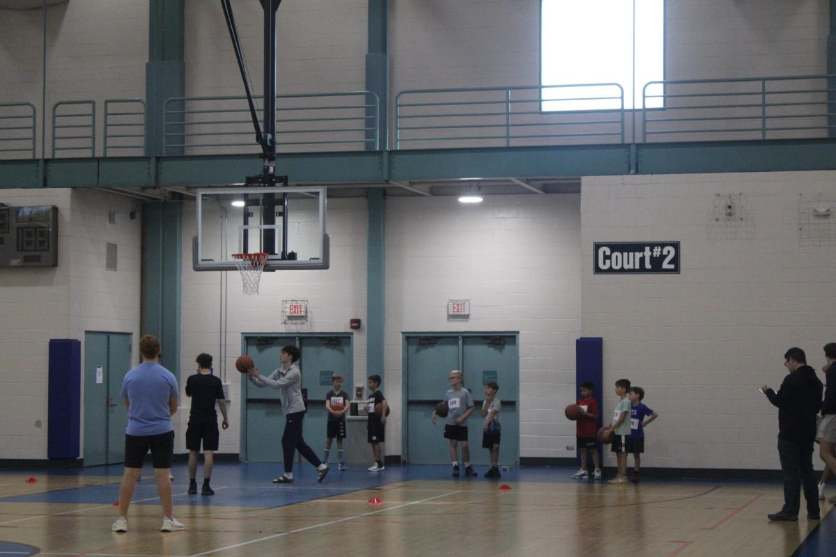 Boys basketball, for Prospect gives back, participates in shooting drills with youth basketball players.