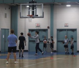 Boys basketball, for Prospect gives back, participates in shooting drills with youth basketball players.