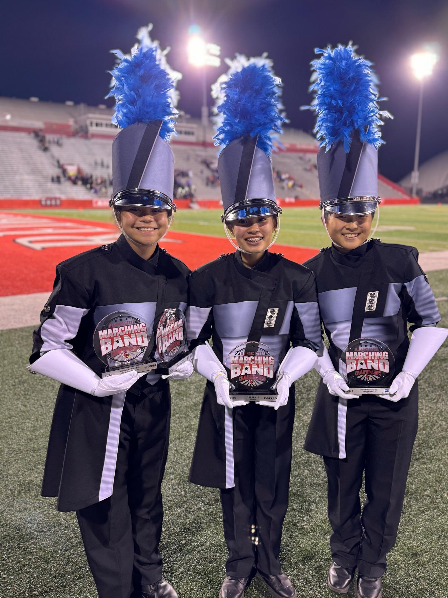 The PMK drum majors holding awards.