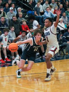 Senior Ryan Lifton charges into the 3-point arc as he is guarded by Viator junior Isaiah McKenny.
