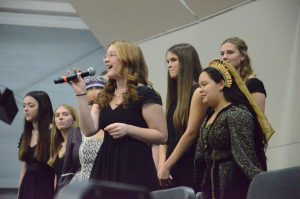 Sophomore Marjorie Savard belts her solo in the final notes of “Santa Tell Me” performed by A Cappella.