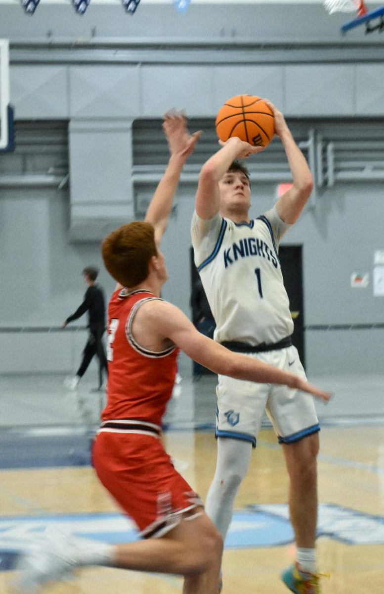 Senior Ben Schneider goes up for a 3 from the top of the key.