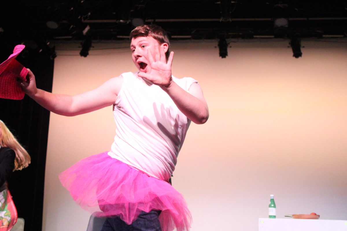 Sophomore Sam Wozniak performs a dance in the skit "Fix it in Post."