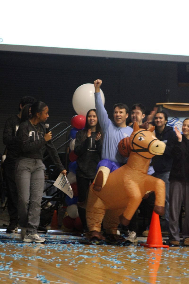 Physics teacher Mike Welter celebrating his inflatable basketball game victory.