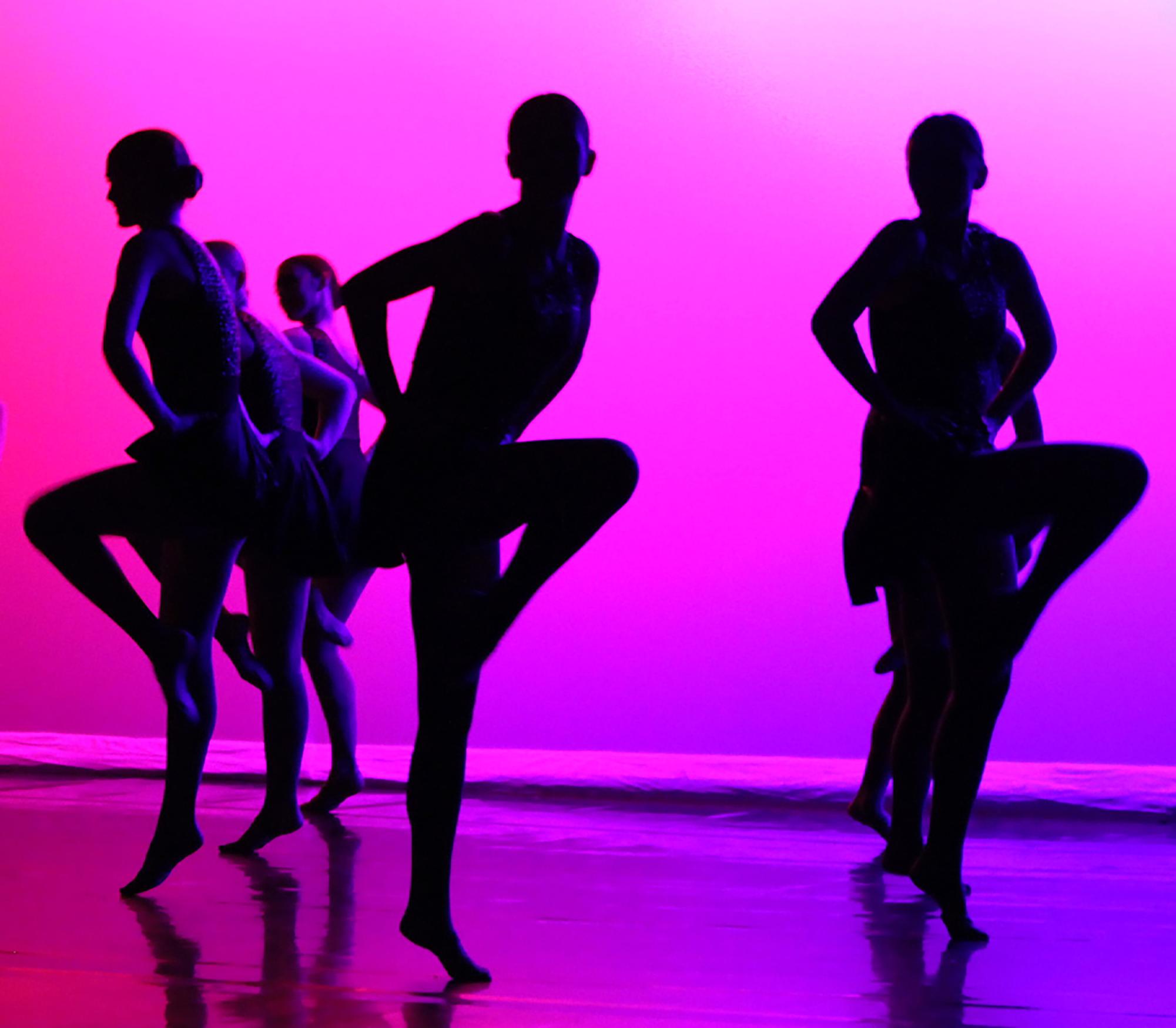 Silhouette of all of orchesis performing during the closing dance entitled "Ignite". 