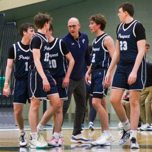 After a timeout, assistant coach John Camardella gives some last minute advice to his players toward the end of the second quarter of Prospect’s regional semifinal game against Schaumburg.
