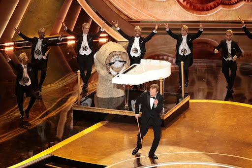 Host Conan O’Brien performs a musical number during his opening monologue ironically titled “I Won’t Waste Time.” photo credit: Myung J. Chun/Los Angeles Times via Getty Images