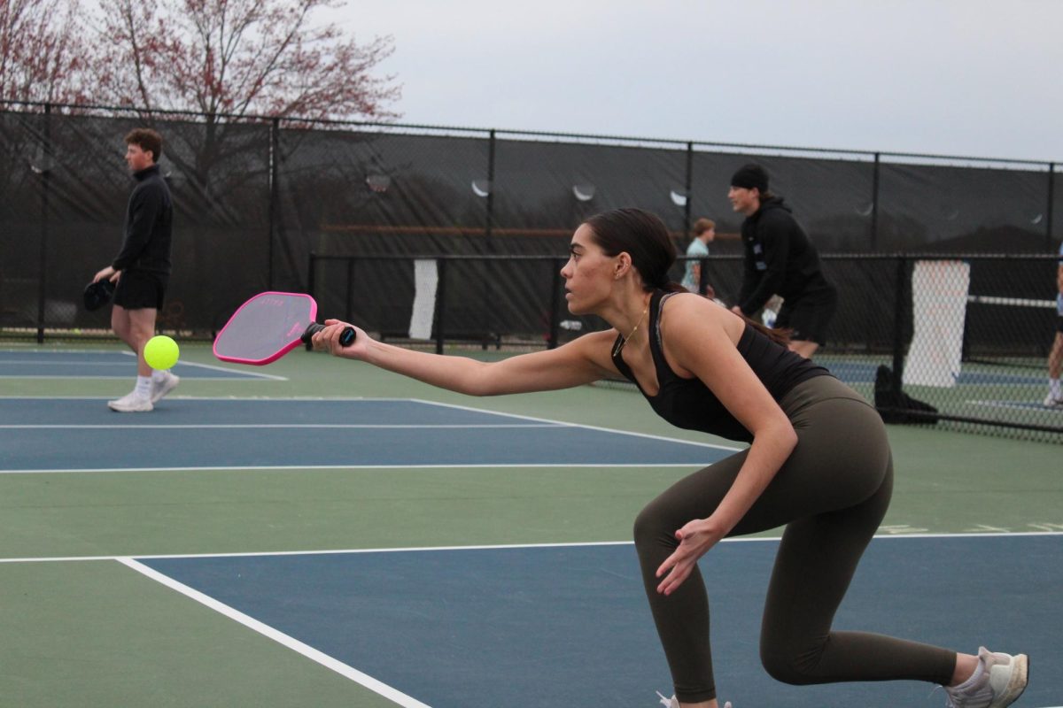 Senior Nalani Albrecht reaches out to save the ball while playing with her partner, senior Olivia Lala. 